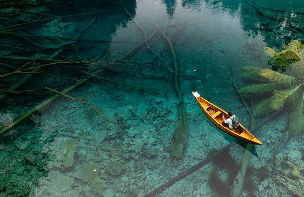 Aerial view of a canoe on clear turquoise water